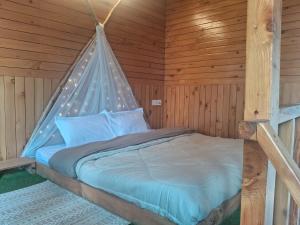 a bedroom with a bed in a wooden room at Bhindeshi Tara Stays Jibhi Mihar in Jibhi +73 photos