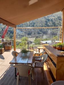 a table and chairs on a deck with a view at Guest House Toska in Berat
