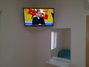 a flat screen tv on the wall of a room at Piso La Buganvilla in Bailén