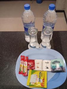 a plate with two bottled water and two water bottles at Holiday Apartment Ragama in Kurukulawa