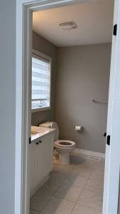 a bathroom with a toilet and a sink and a window at Home Sweet Home in Ottawa +25 photos