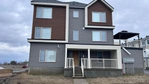 a large house with a porch and a balcony at Home Sweet Home in Ottawa