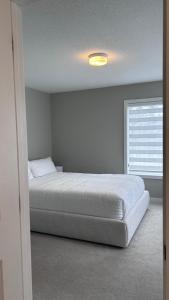 a bedroom with a bed and a window at Home Sweet Home in Ottawa