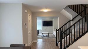 a living room with a staircase leading to a living room at Home Sweet Home in Ottawa