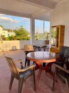a patio with a wooden table and chairs at Coorg Nature vista in Kushālnagar