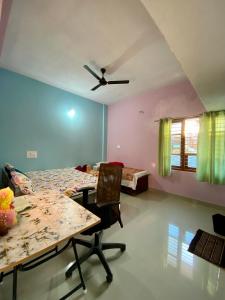 a room with a table and a ceiling fan at Coorg Nature vista in Kushālnagar