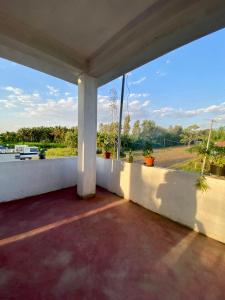 a balcony with a view of a field at Coorg Nature vista in Kushālnagar +7 photos