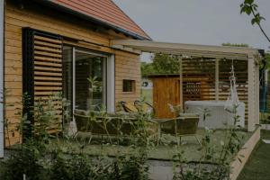 a patio with a table and chairs in front of a house at WOWCABIN - Lovas in Lovas