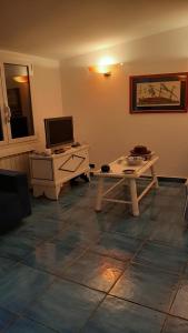 a living room with a desk and a computer on a table at la Baracca in Genoa