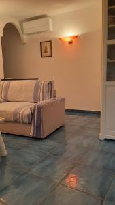 a bedroom with a bed sitting on a tiled floor at la Baracca in Genoa