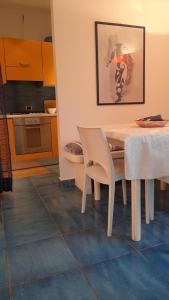 a dining room with a table and a kitchen at la Baracca in Genoa +10 photos