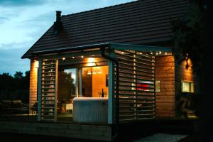 a house with a large window with a hot tub at WOWCABIN - Lovas in Lovas
