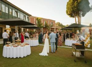 a bride and groom standing in front of tables with food at Hotel Rural VN Tenorio in Pontevedra