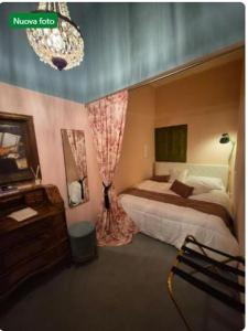 a bedroom with a bed and a dresser and a mirror at Vicolo Re suite in centro con stile in Porto Empedocle