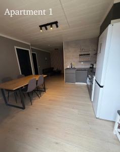 a kitchen and dining room with a table and a refrigerator at Vikavegen Stryn in Stryn +9 photos