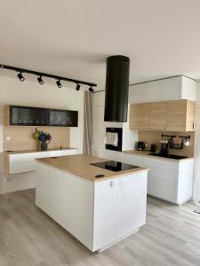 a kitchen with white cabinets and a counter top at Modern House with Private Pool & Terrace in Červená Třemešná