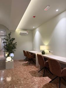 an office with a table and chairs and a plant at Asimmy Hotel in Kampong Gurun