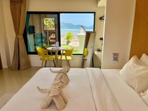 a stuffed animal sitting on top of a bed at South Beach Inn in Nathon Bay +119 photos