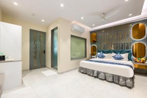 a bedroom with a large bed with a blue headboard at The Arjun - Newly Built Hotel Just 3 Mins from Metro and Railway Station in New Delhi