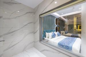 a master bedroom with a large mirror and a bed at The Arjun - Newly Built Hotel Just 3 Mins from Metro and Railway Station in New Delhi