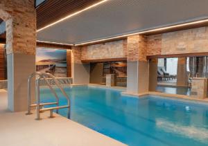 a swimming pool in a building with a swimming poolvisor at Hotel Nova Riviera in Ohrid