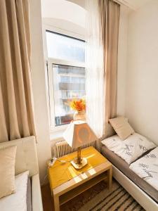 a small living room with a couch and a table at Beenie 16 in Linz