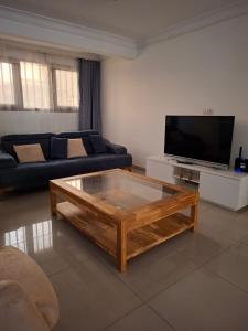a living room with a couch and a coffee table at Monica Place in Abidjan