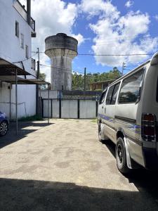 a white van parked in front of a silo at Hiker's Hub in Maskeliya