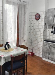 a kitchen with a table with a table cloth on it at Grazioso bilocale in Giusvalla +20 photos