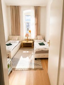 a small room with two beds and a window at Beenie 16 in Linz