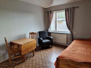 a bedroom with a bed and a desk and a chair at Bettan in Bruzaholm