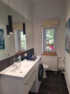 a bathroom with a sink and a washing machine at Studio Nałęczów in Nałęczów +20 photos