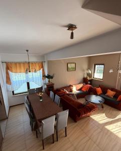 a living room with a couch and a table at Dom nad jeziorem Mazury pomost segment 2 in Giżycko
