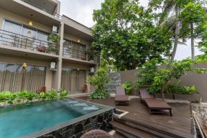 a hotel with a swimming pool in front of a building at Aqualuna Weligama in Weligama