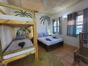 a bedroom with two bunk beds in a room at Lõst Soles Lodge in Jambiani