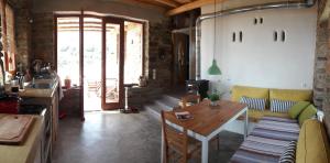 a living room with a couch and a table at Tinos Ecolodge in Tinos +28 photos