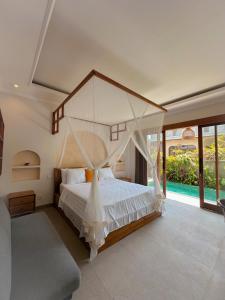 a bedroom with a large bed with a canopy at Kukuh House Ubud in Ubud +166 photos