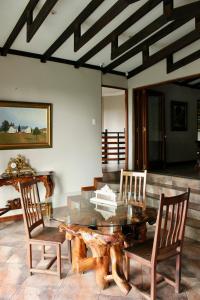 a dining room with a glass table and two chairs at inn on mars in Pretoria