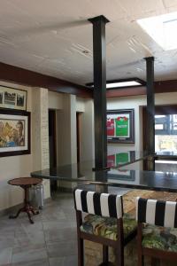 a dining room with a glass table and two chairs at inn on mars in Pretoria