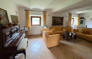 a large living room with couches and a piano at Lovely Home In Tarquinia in Tarquinia