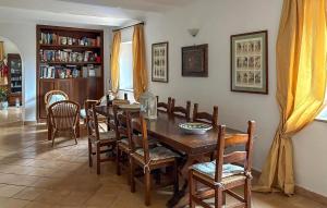 a dining room with a wooden table and chairs at Lovely Home In Tarquinia in Tarquinia