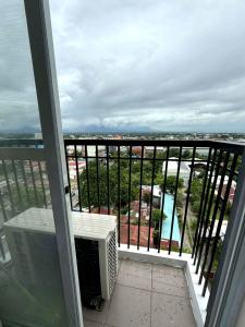 a room with a balcony with a view of a city at Residencias Lim - Cityscape Residences in Bacolod