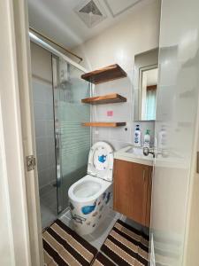 a small bathroom with a toilet and a shower at Residencias Lim - Cityscape Residences in Bacolod