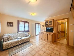a living room with a couch and a tv at Cèsa Aurora in Canazei +34 photos