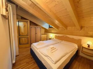 a bedroom with a bed with two towels on it at Cèsa Aurora in Canazei