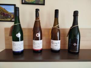 three bottles of wine sitting on a shelf at Ferienwohnung Brigatt in Klotten
