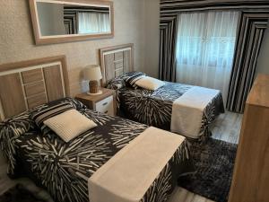 a hotel room with two beds and a mirror at CHEPIBAROS Turismo in San Pedro +31 photos