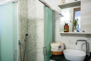 a bathroom with a shower with a toilet and a sink at Vrachos Nature Lodges PRINOS 3, Private pool in Agia Galini