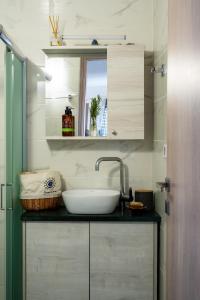 a bathroom with a sink and a mirror at Vrachos Nature Lodges PRINOS 3, Private pool in Agia Galini