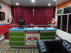a stage with a table in a room at Hotel Red Roof & Restaurant in Abbottabad